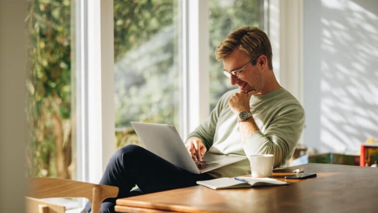 A man reading something on his laptop