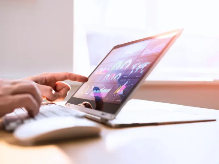 A person looks at analytics on their laptop.