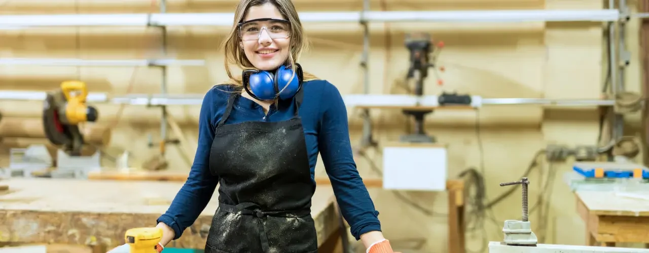 A young woman working in a carpenter shop