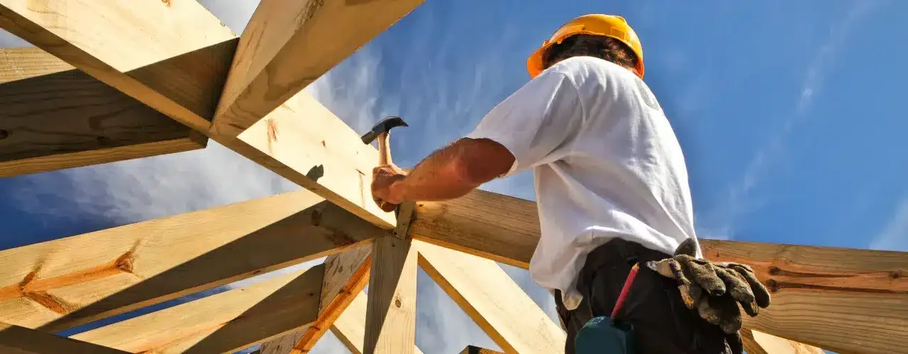 A builder working a house